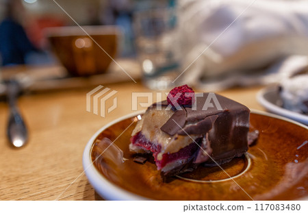 bitten cake in a cafe on a plate 117083480
