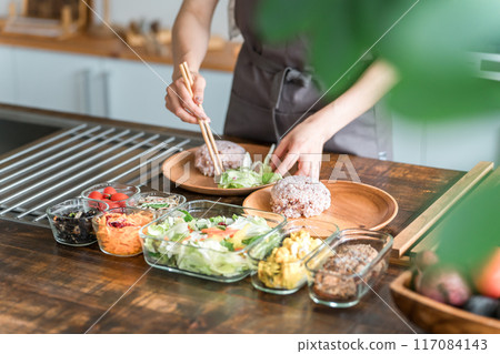A housewife serving a one-plate lunch in the kitchen A housewife serving a one-plate lunch in the kitchen 117084143