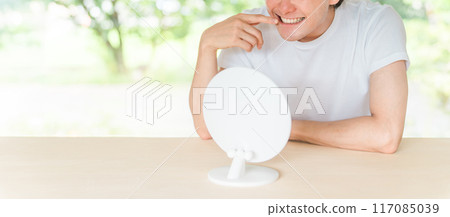 Whitening, teeth alignment, orthodontics, young man concerned about teeth (toothache) 117085039