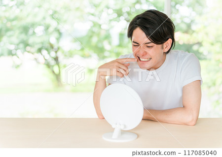 Whitening, teeth alignment, orthodontics, young man concerned about teeth (toothache) 117085040