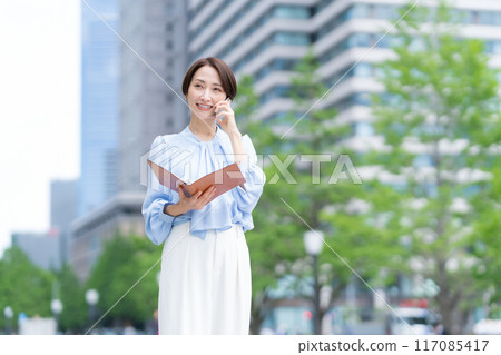 Middle-aged business woman working in an office district 117085417