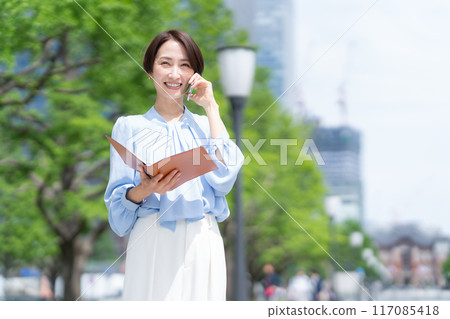 Middle-aged business woman working in an office district 117085418