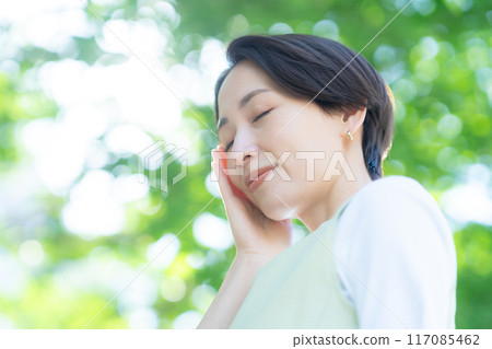 A middle-aged woman taking UV care 117085462