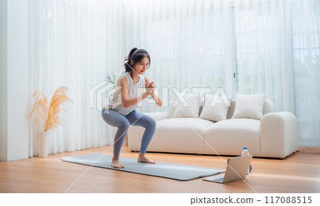 Young Asian beautiful woman doing aerobic exercise at home 117088515