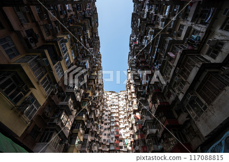 Yick Fat Building, Quarry Bay, Hong Kong. Residential area in old apartment with windows. High-rise building, skyscraper with windows of architecture in urban city. Yick Fat Building, Quarry Bay, Hong Kong. Residential area in old apartment with windows. High-rise building, skyscraper with windows of architecture in urban city. 117088815