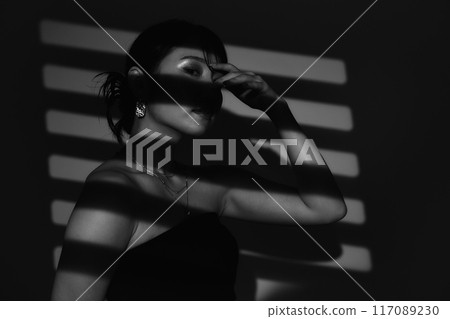 Female portrait in light and shadow 117089230