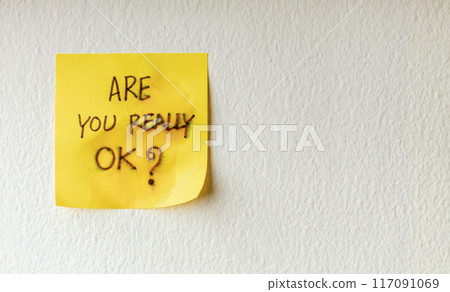Mind, Mental Health and Encouragement Concepts. a Sticky Note with the Meaning of Care was taped on the white Wall Mind, Mental Health and Encouragement Concepts. a Sticky Note with the Meaning of Care was taped on the white Wall 117091069