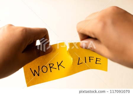 Work Life Balance Copceptual Photo, Hand Tearing Paper with Work and Life Text, Tear it Completely apart Work Life Balance Copceptual Photo, Hand Tearing Paper with Work and Life Text, Tear it Completely apart 117091070