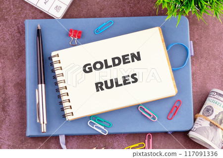 Conceptual golden rule symbol. Copy space. GOLDEN RULES words in the notebook. View from above Conceptual golden rule symbol. Copy space. GOLDEN RULES words in the notebook. View from above 117091336