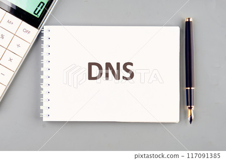 DNS (Domain Name System) acronym. DNS in a notebook on a gray background DNS (Domain Name System) acronym. DNS in a notebook on a gray background 117091385