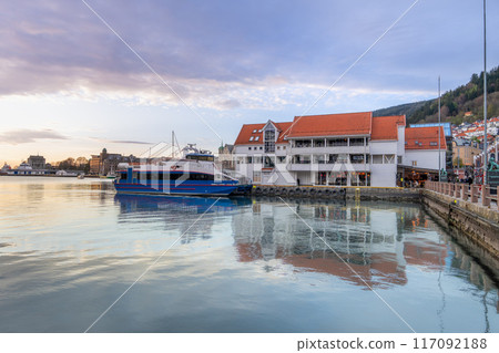 A ferry docked in Bergen harbor at sunset. A ferry docked in Bergen harbor at sunset. 117092188