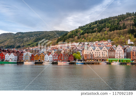 Colorful Bryggen Waterfront with Boats Docked, Bergen, Norway. 117092189