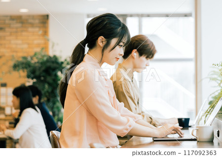 People working in a shared office 117092363