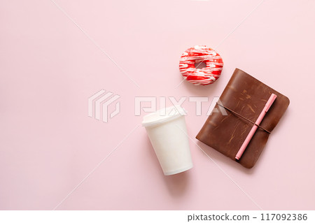Disposable coffee cup, donut and brown notebook. Time break and productivity concept. Disposable coffee cup, donut and brown notebook. Time break and productivity concept. 117092386