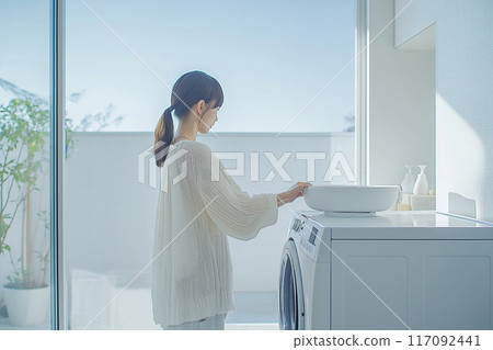 Image of a laundry room: young woman 117092441