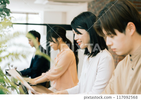 People working in a shared office 117092568