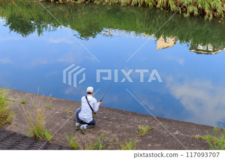 People fishing in a small river early in the morning People fishing in a small river early in the morning 117093707