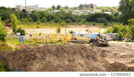 Excavator in a construction pit, heavy machinery. Engineering project presentations. Construction dig, excavator in pit, banner design. Yellow excavator digging Excavator in a construction pit, heavy machinery. Engineering project presentations. Construction dig, excavator in pit, banner design. Yellow excavator digging 117094912