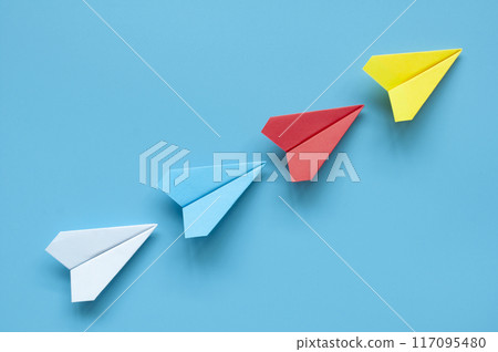 Yellow paper airplane origami leading other multicolored paper airplanes on blue background representing diversity and inclusion Yellow paper airplane origami leading other multicolored paper airplanes on blue background representing diversity and inclusion 117095480