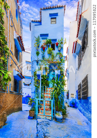 Chefchaouen, Morocco. Blue medina, ancient city, staircase and wall decorated with colourful flowerpots. Chefchaouen, Morocco. Blue medina, ancient city, staircase and wall decorated with colourful flowerpots. 117095822