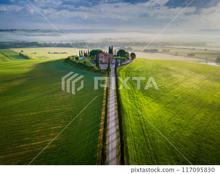 Tuscany, Italy. Tranquil morning fog and typical Tuscan landscape in countryside, cypress trees. Tuscany, Italy. Tranquil morning fog and typical Tuscan landscape in countryside, cypress trees. 117095830