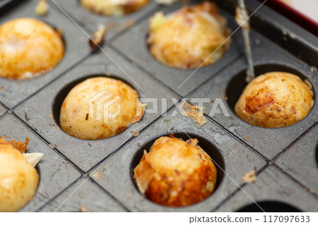 Homemade takoyaki made with a takoyaki maker Homemade takoyaki made with a takoyaki maker 117097633