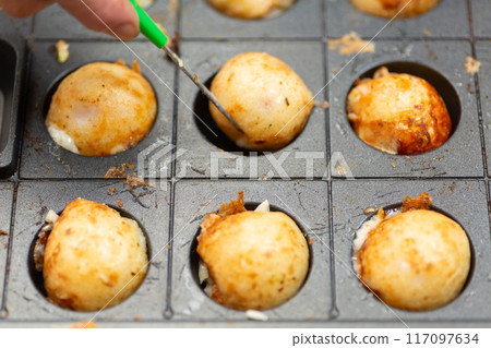 Homemade takoyaki made with a takoyaki maker Homemade takoyaki made with a takoyaki maker 117097634