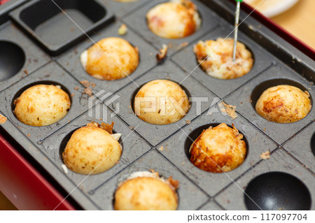 Homemade takoyaki made with a takoyaki maker Homemade takoyaki made with a takoyaki maker 117097704