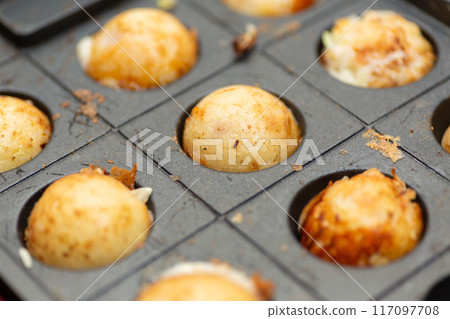 Homemade takoyaki made with a takoyaki maker Homemade takoyaki made with a takoyaki maker 117097708