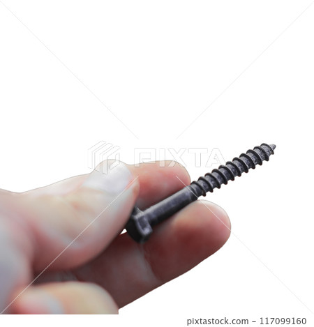 Caucasian man's hand holds with his fingers a blackened large fastening screw with a self-cutting spiral to fix wooden materials, isolated against a white background. Blank for artworks 117099160