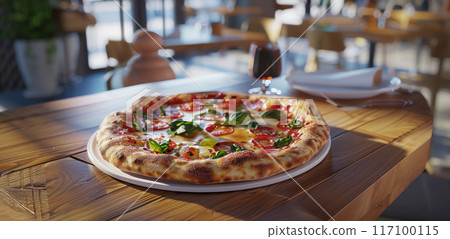 Close-up of fresh baked Italian pizza on old rustic wooden table in restaurant background 117100115