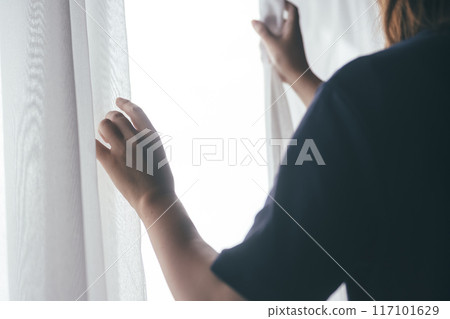 A woman by the window 117101629