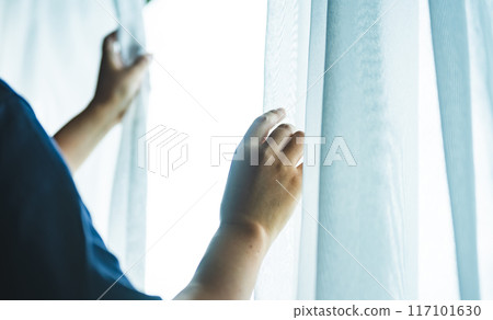 A woman by the window 117101630