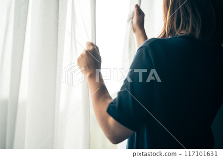 A woman by the window 117101631