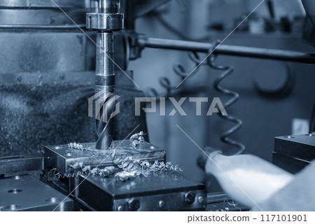The drilling process on NC milling machine with metal material in the light blue scene. The drilling process on NC milling machine with metal material in the light blue scene. 117101901