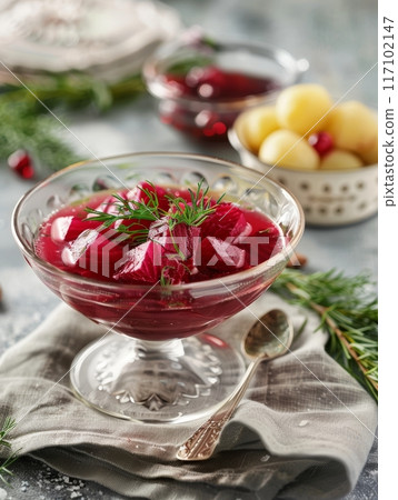 Traditional Lithuanian cold beet soup, saltibarsciai, served in a glass bowl alongside boiled potatoes. This vibrant, chilled dish represents the unique culinary heritage of Eastern Europe. 117102147