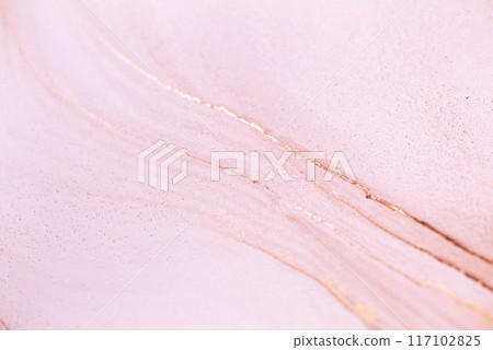 A close-up shot of a light pink surface with delicate gold veins. The texture is smooth and slightly glittery A close-up shot of a light pink surface with delicate gold veins. The texture is smooth and slightly glittery 117102825