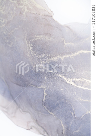 A close-up shot of a lavender and white ink swirl, showcasing the intricate patterns and textures created by the fluid movement of the inks 117102833