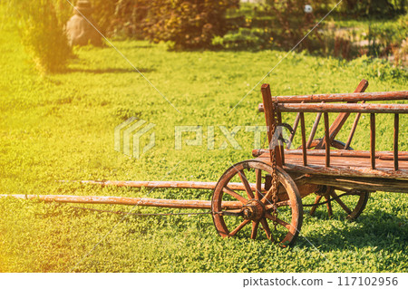 Gardening And Housekeeping. Vintage Cart On Summer Sunny Day. Decorative Peasant Cart On Summer Lawn. Bright Sunny Day. Garden Decoration Concept. Garden Wagon. Copy Space 117102956