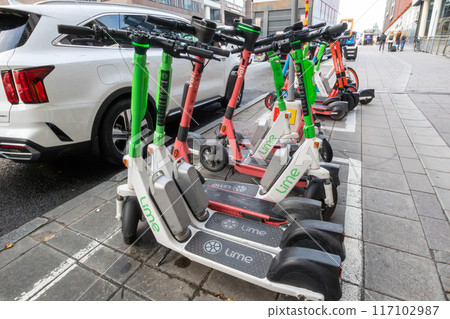 Rental electric kick scooter parked in Stockholm, Sweden, Europe 117102987