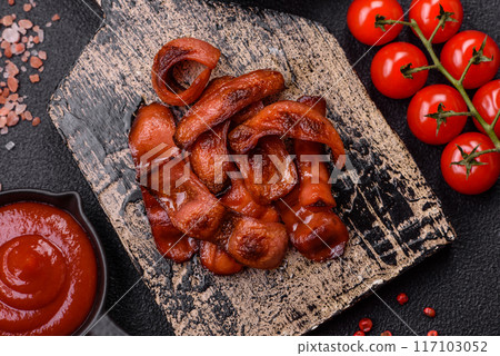 Fried sausages sliced with salt and spices as an ingredient for an English breakfast Fried sausages sliced with salt and spices as an ingredient for an English breakfast 117103052