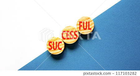 Successful symbol. Concept word Successful on beautiful wooden circles. Beautiful blue white background. Business successful concept. Copy space. Successful symbol. Concept word Successful on beautiful wooden circles. Beautiful blue white background. Business successful concept. Copy space. 117103282
