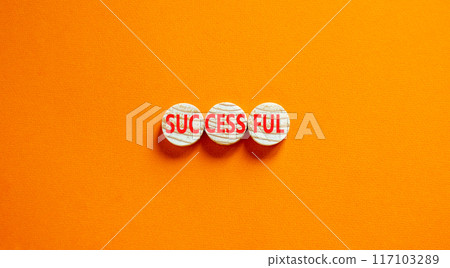 Successful symbol. Concept word Successful on beautiful wooden circles. Beautiful orange background. Business successful concept. Copy space. Successful symbol. Concept word Successful on beautiful wooden circles. Beautiful orange background. Business successful concept. Copy space. 117103289