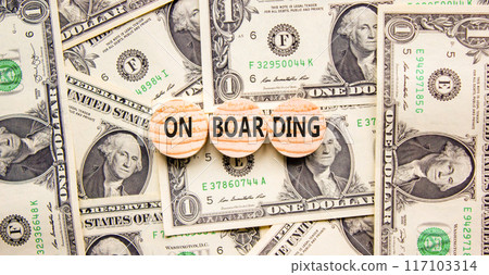 Onboarding success symbol. Concept word Onboarding on wooden circles. Dollar bills. Beautiful background from dollar bills. Business onboarding success concept. Copy space. 117103314