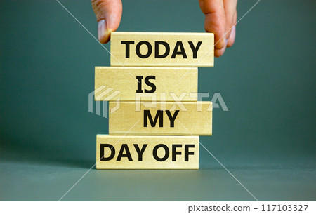Today is my day off symbol. Concept words Today is my day off on wooden blocks. Businessman hand. Beautiful grey table grey background. Today is my day off business concept. Copy space. 117103327