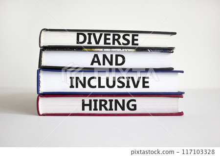 Diverse and inclusive hiring symbol. Books with words Diverse and inclusive hiring on beautiful white background. Businessman hand. Business, HR, diverse inclusive hiring concept. Copy space. Diverse and inclusive hiring symbol. Books with words Diverse and inclusive hiring on beautiful white background. Businessman hand. Business, HR, diverse inclusive hiring concept. Copy space. 117103328