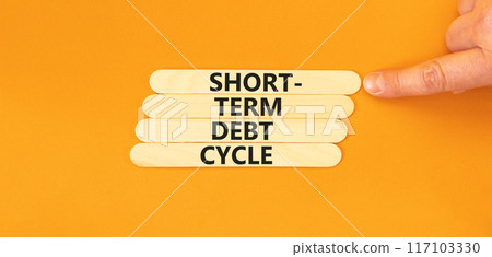 Short-term debt cycle symbol. Concept words Short-term debt cycle on wooden stick. Beautiful orange table orange background. Businessman hand. Business Short-term debt cycle concept. Copy space. Short-term debt cycle symbol. Concept words Short-term debt cycle on wooden stick. Beautiful orange table orange background. Businessman hand. Business Short-term debt cycle concept. Copy space. 117103330