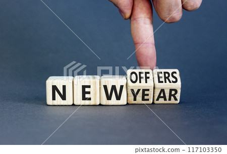 New year and offers symbol. Concept word New year New offers on beautiful wooden cubes. Beautiful grey table grey background. Businessman hand. Business new year and offers concept. Copy space. 117103350