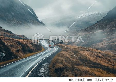 Car journeys on a curvy mountain road amidst a mystical foggy landscape Car journeys on a curvy mountain road amidst a mystical foggy landscape 117103687