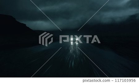 the car is driving on the road at night, cloudy sky and rain 117103956